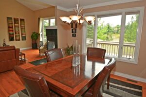 beautiful wooden dining table in dining room with great backyard views