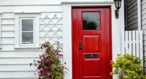 red door on a white house in lapeer