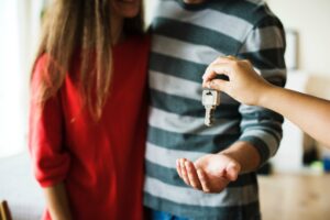new home buyers receiving the keys to their new home