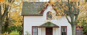 white with red trim cottage type home in imlay city